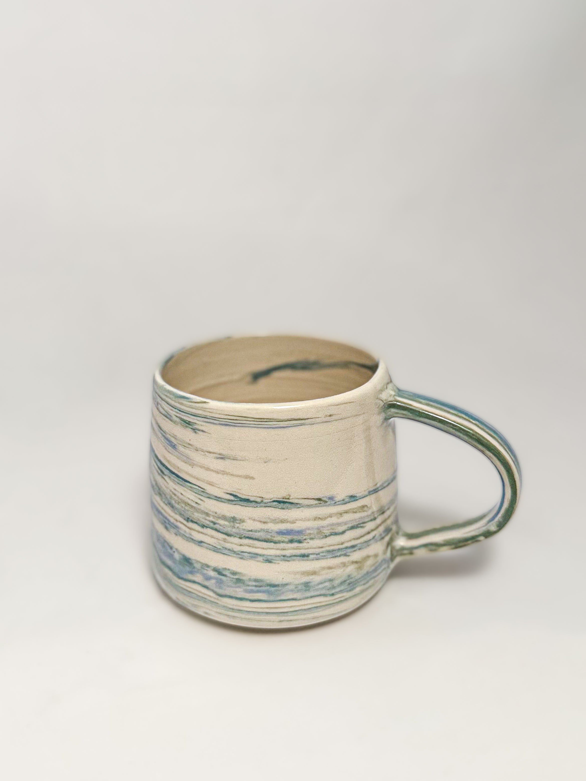 A blue and white marbled stoneware mug