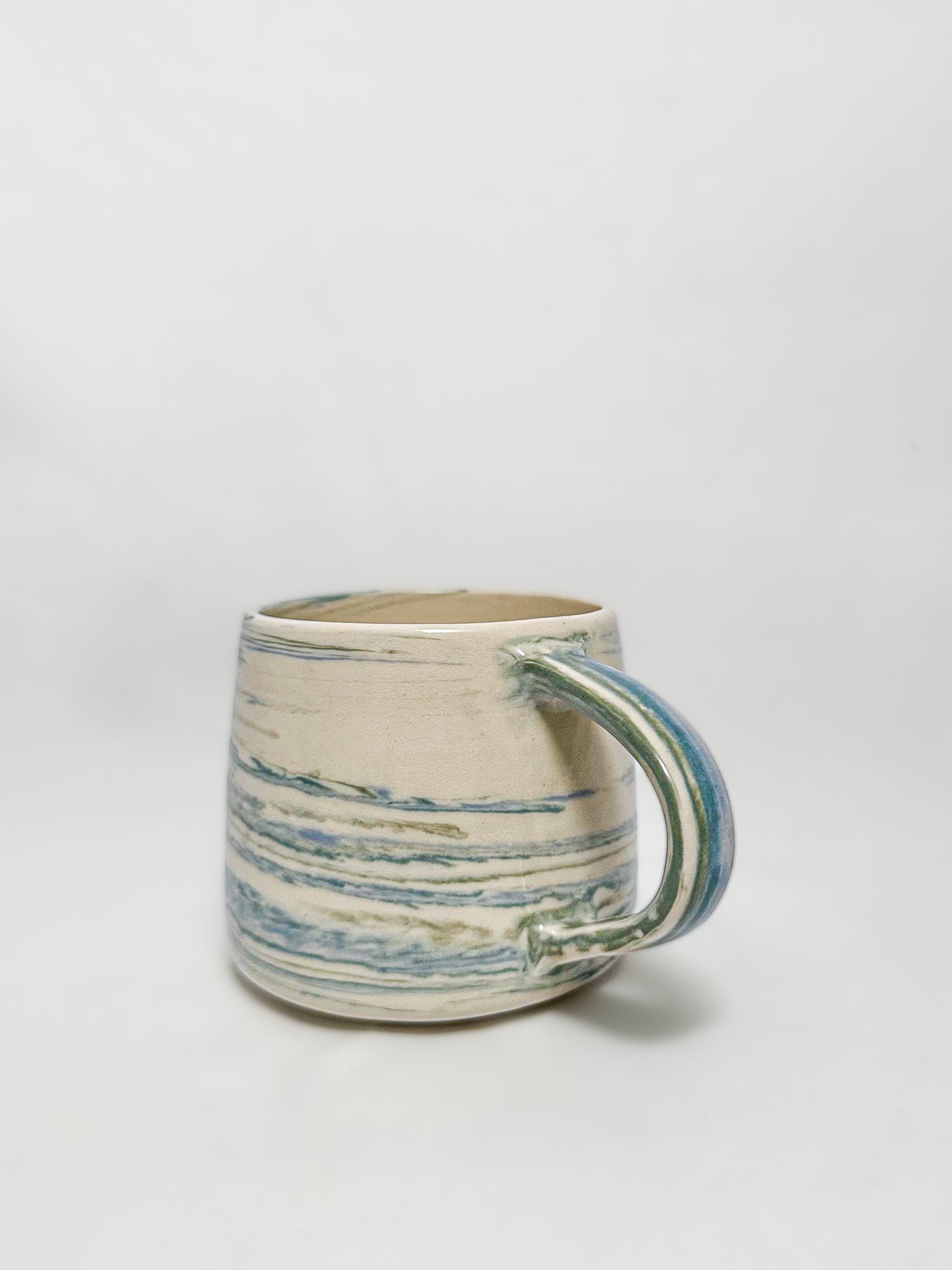 A blue and white marbled stoneware mug