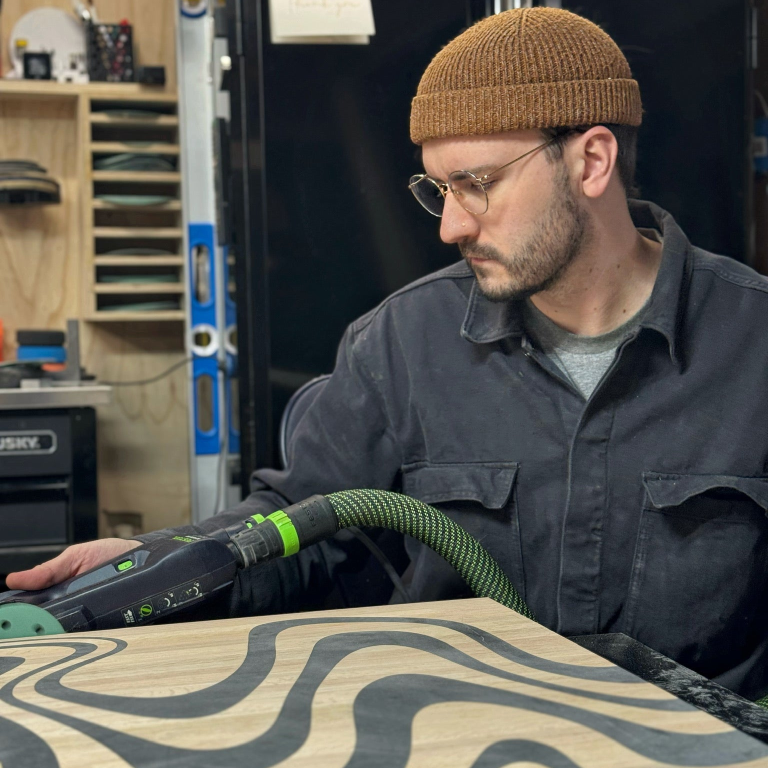 Elmstone Studio owner, sanding away at a custom table build. 