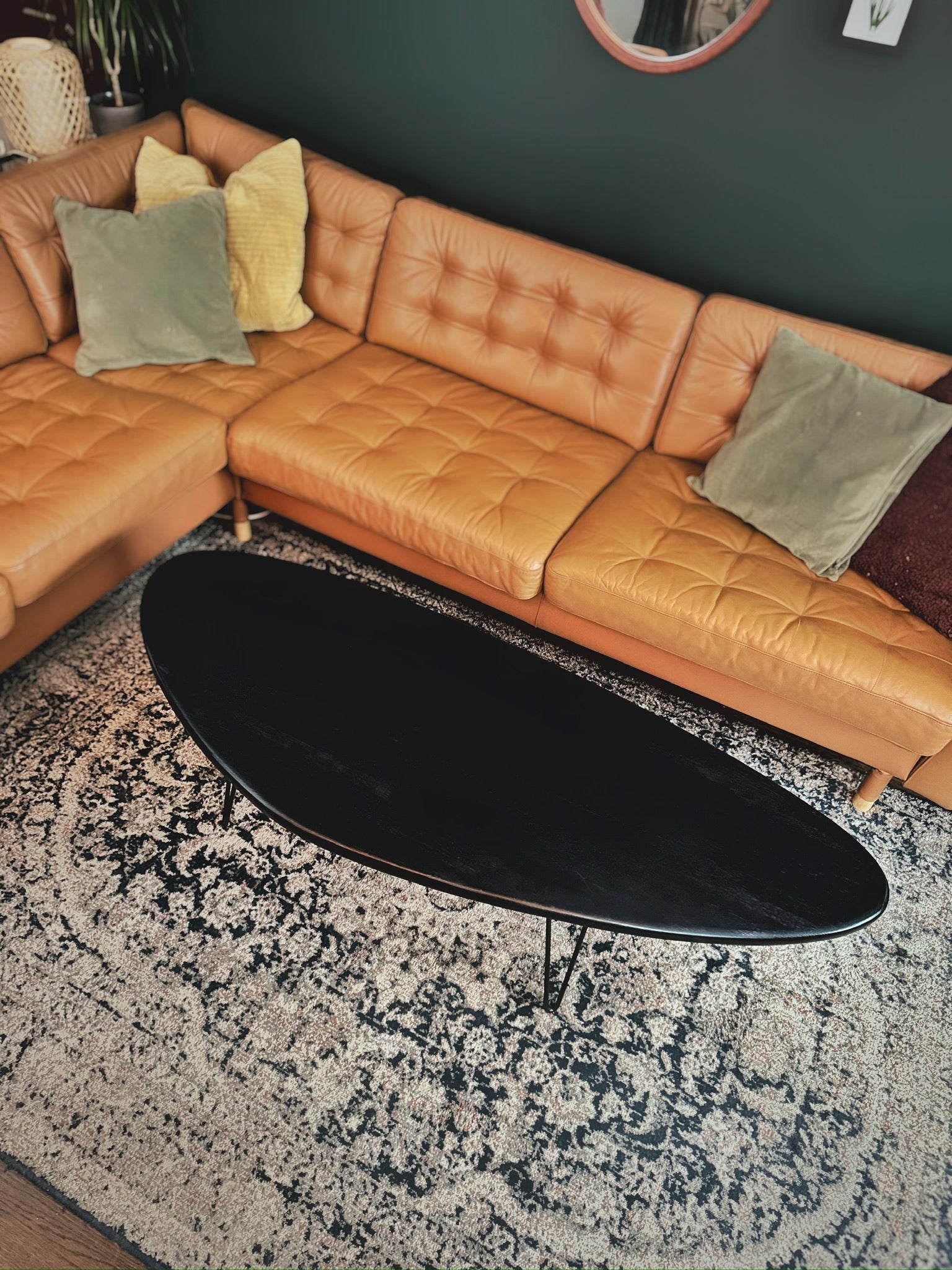 The Eclipse Table – a solid wood, kidney bean-shaped coffee table with a Scandinavian mid-century modern design, supported by sleek black hairpin legs.