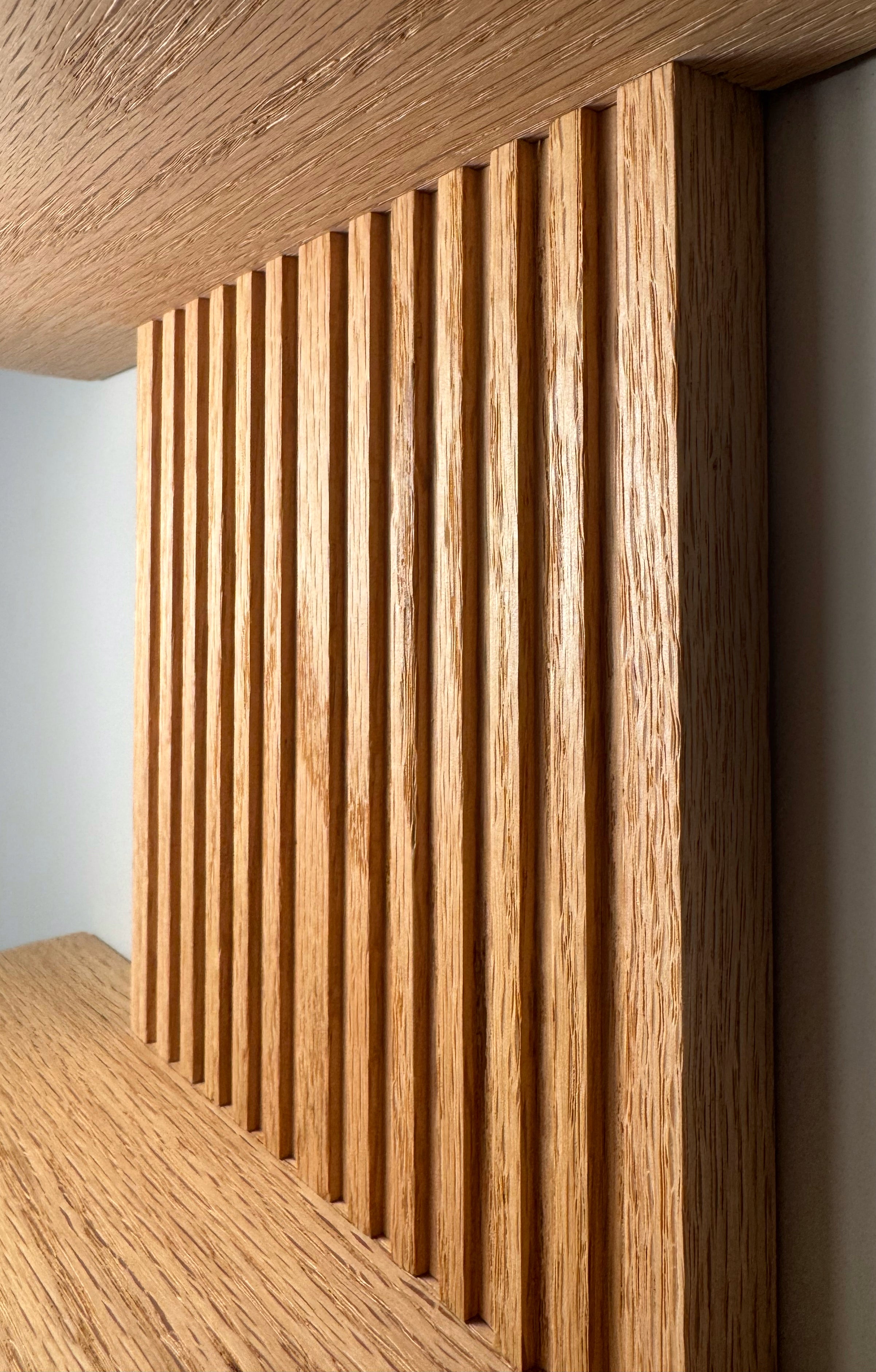 Contemporary oak crescent shelf with a two-tier design, clear protective finish, and simple keyhole installation for wall decor.