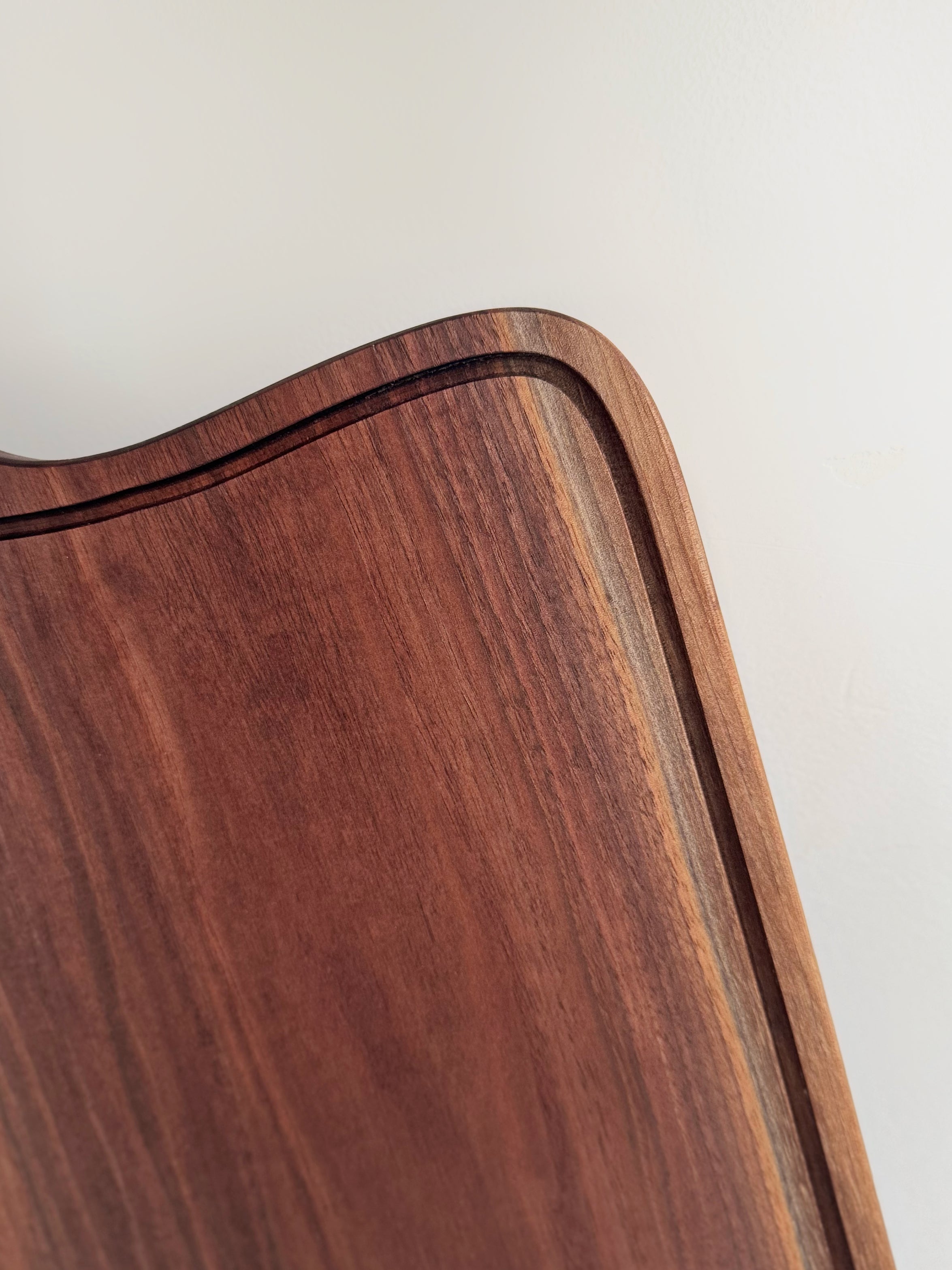 Premium walnut cutting board, The Mallard, ideal for serving smoked meats, bread, and appetizers.
