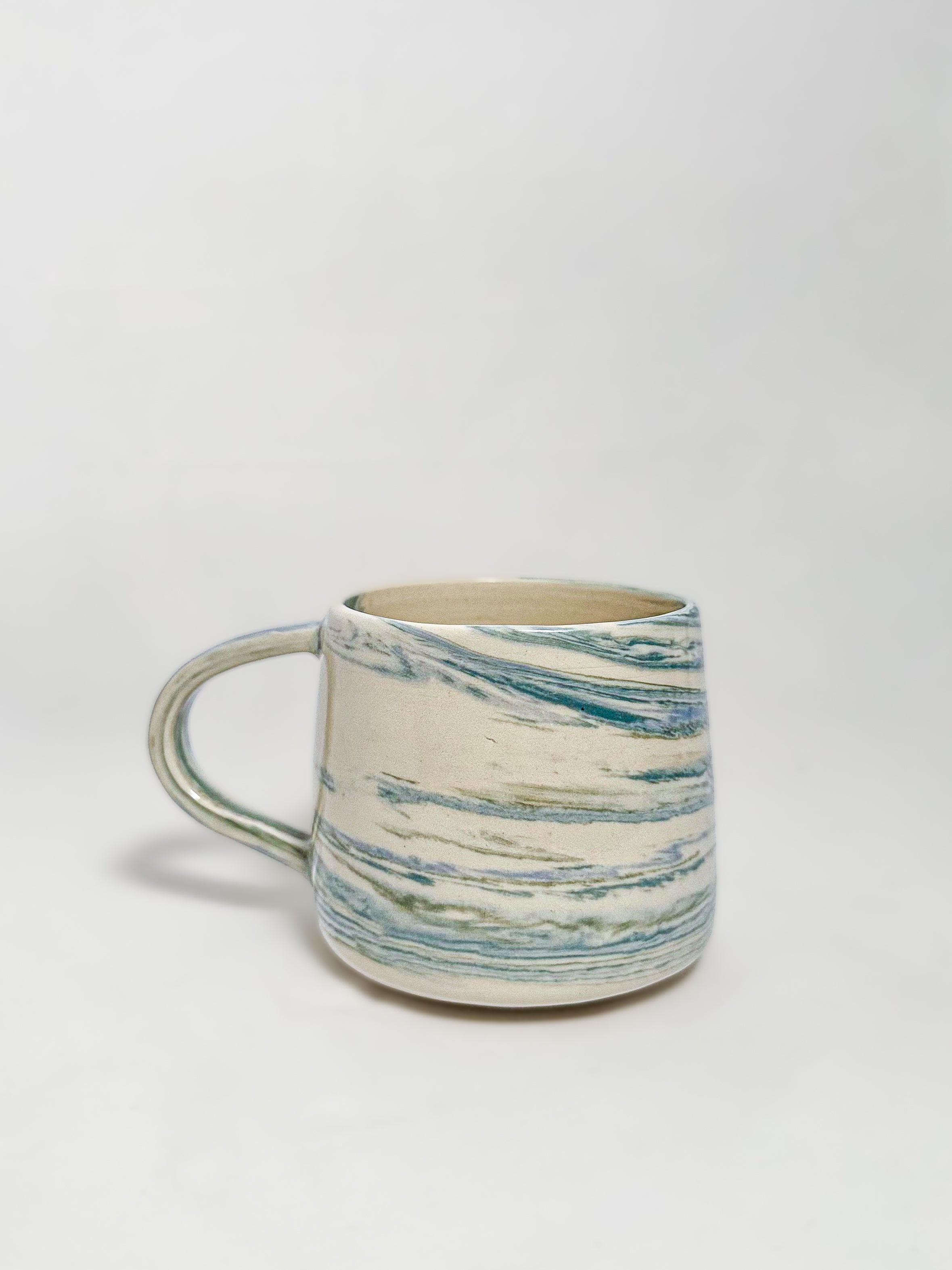 A blue and white marbled stoneware mug 