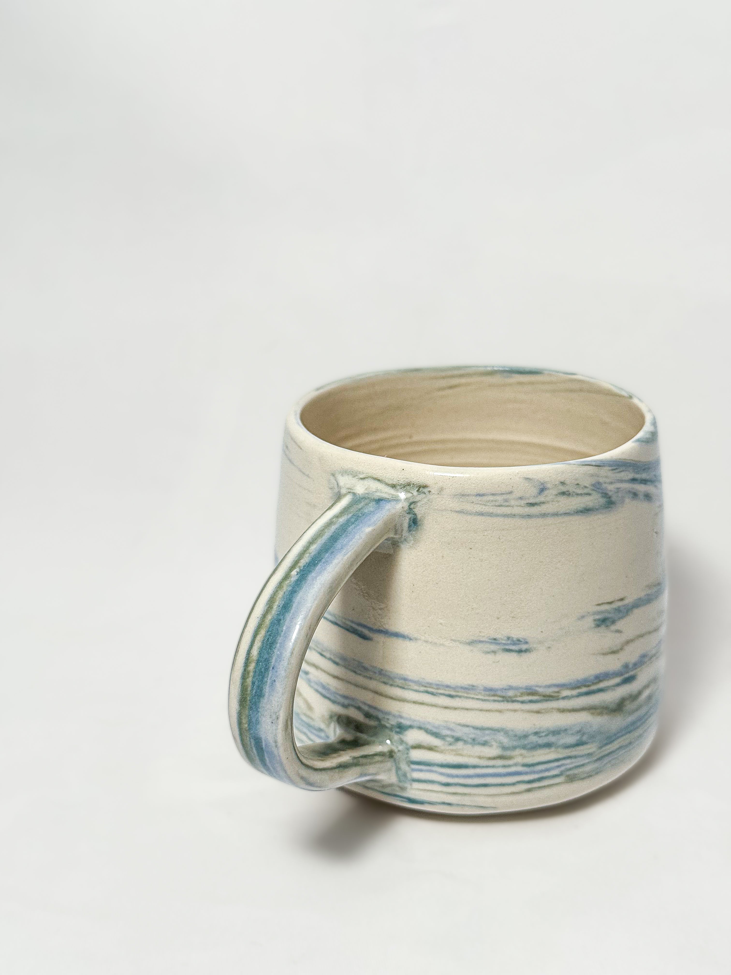 A blue and white marbled stoneware mug 