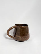 A brown marbled stoneware mug with swirls of light brown and dark brown clay