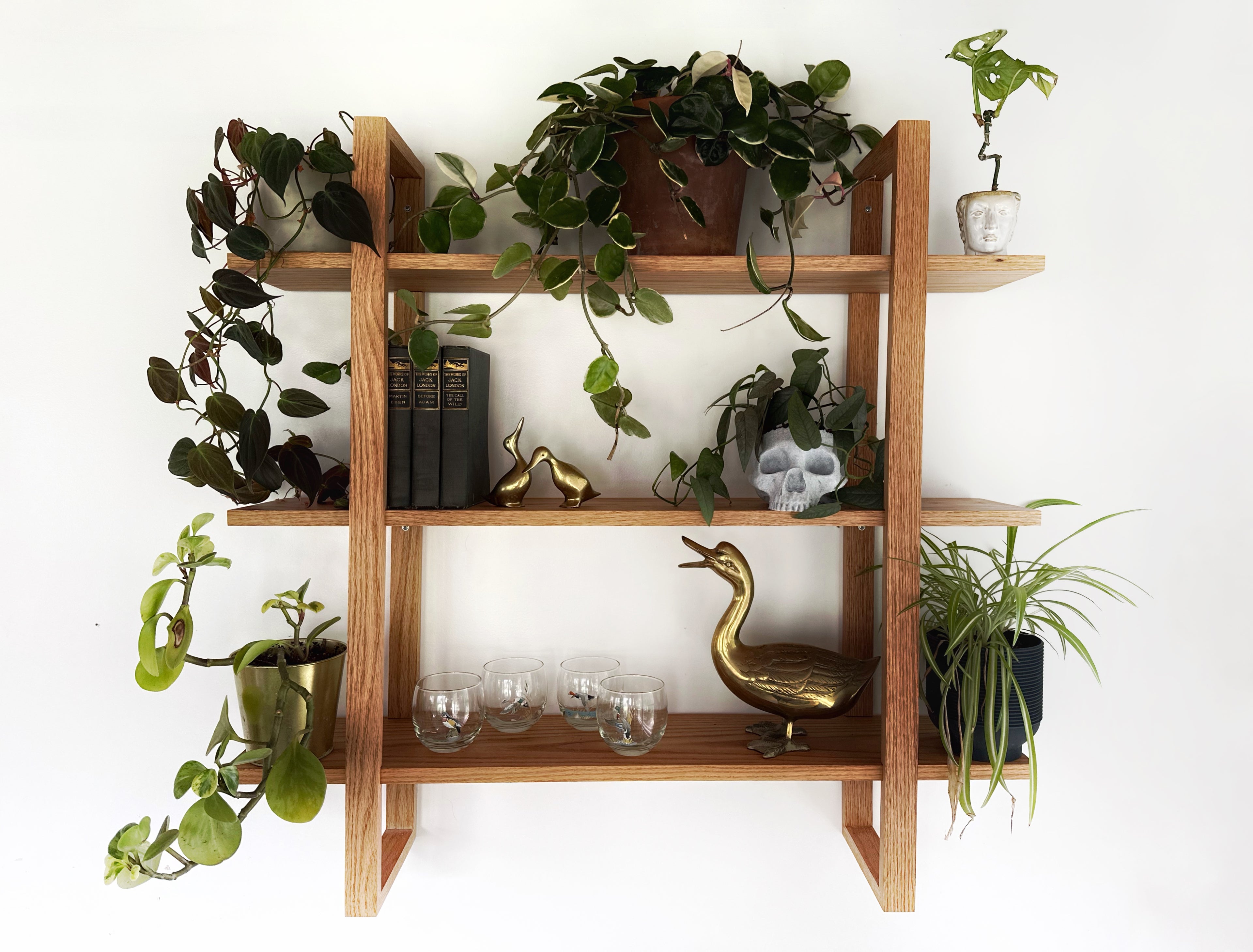 Handmade wooden wall shelf, The Crescent, featuring straight fluted brackets and a natural finish.