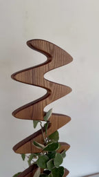 The Serpentine wooden plant support, a minimalist and modern stake for climbing plants, crafted by Elmstone.