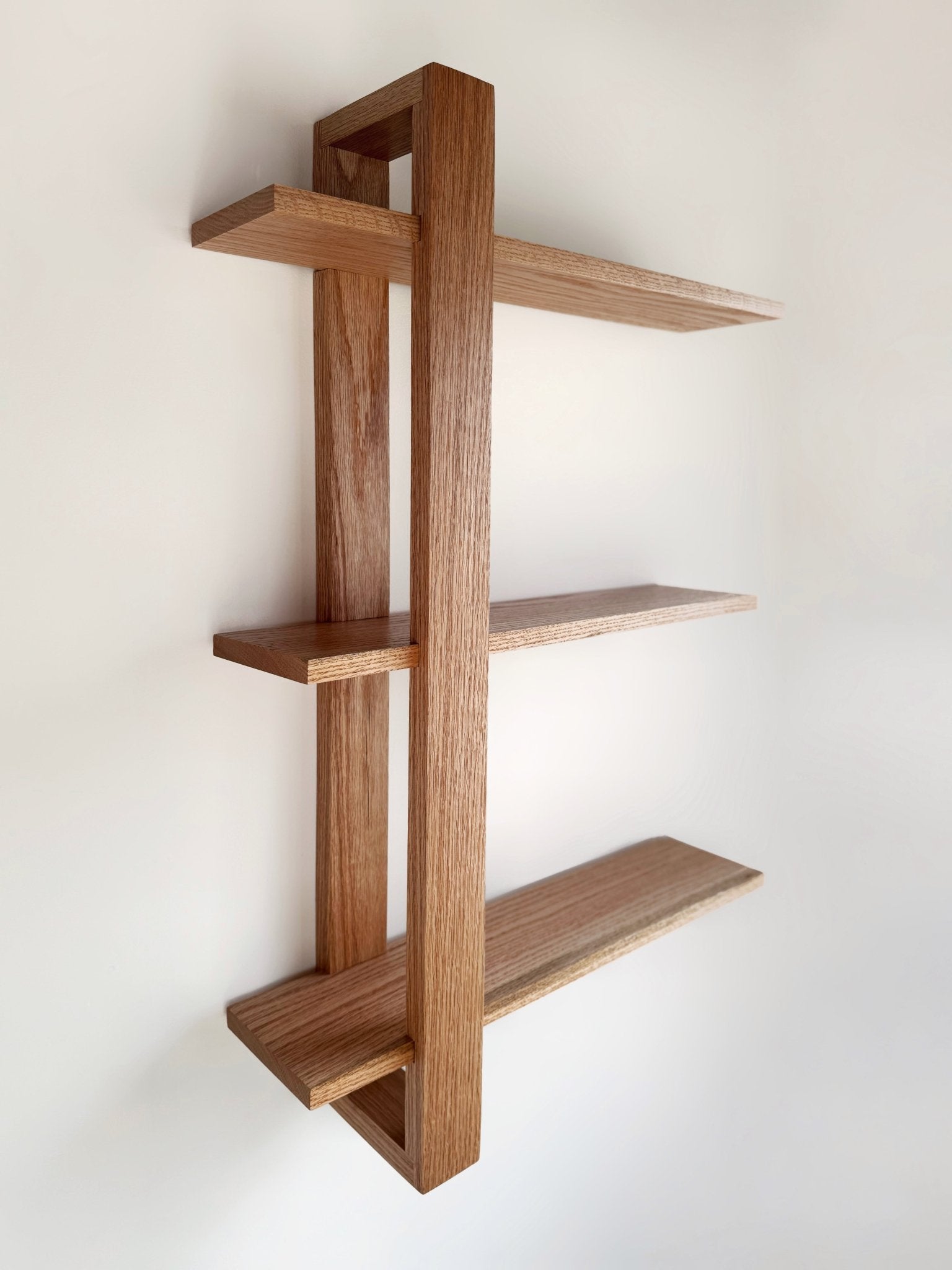 Handmade wooden shelf, The Odyssey, featuring a single bracket for a modern floating design.