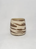 A marbled ceramic stoneware tumbler with brown and white clay