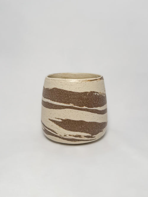 A marbled ceramic stoneware tumbler with brown and white clay