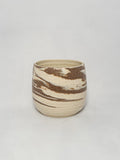 A marbled ceramic stoneware tumbler with brown and white clay