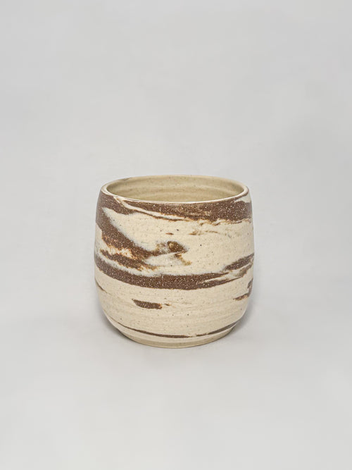 A marbled ceramic stoneware tumbler with brown and white clay